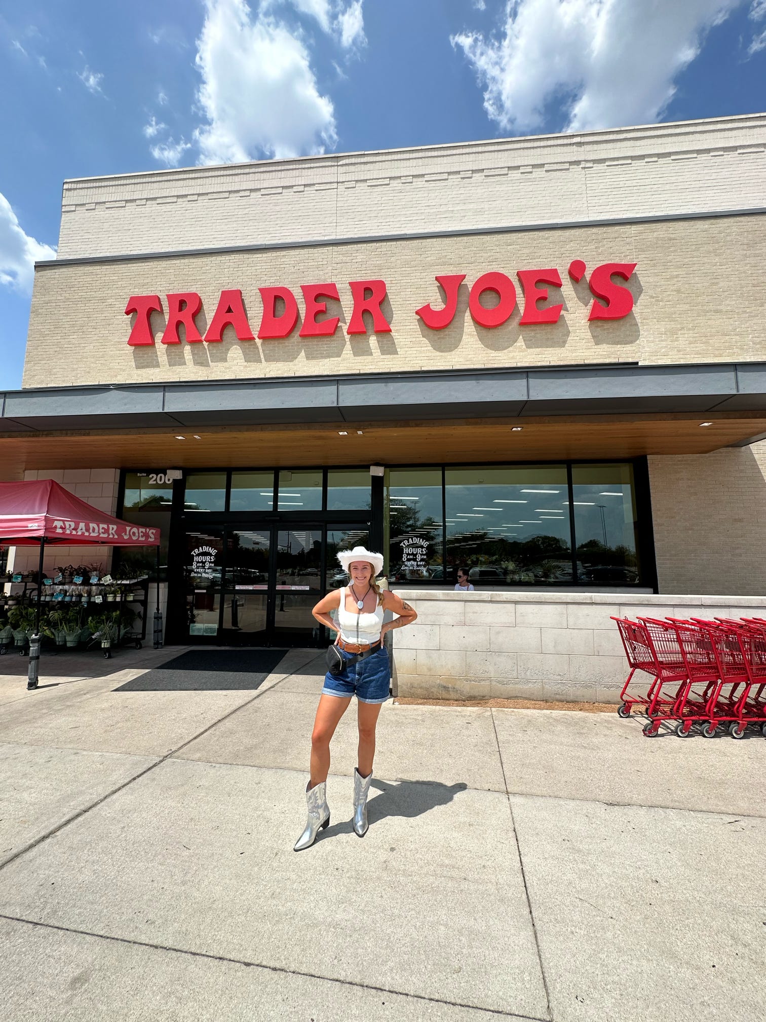 The bride to be stands in front of trader joes in Austin, Texas before grocery shopping for her bachelorette.